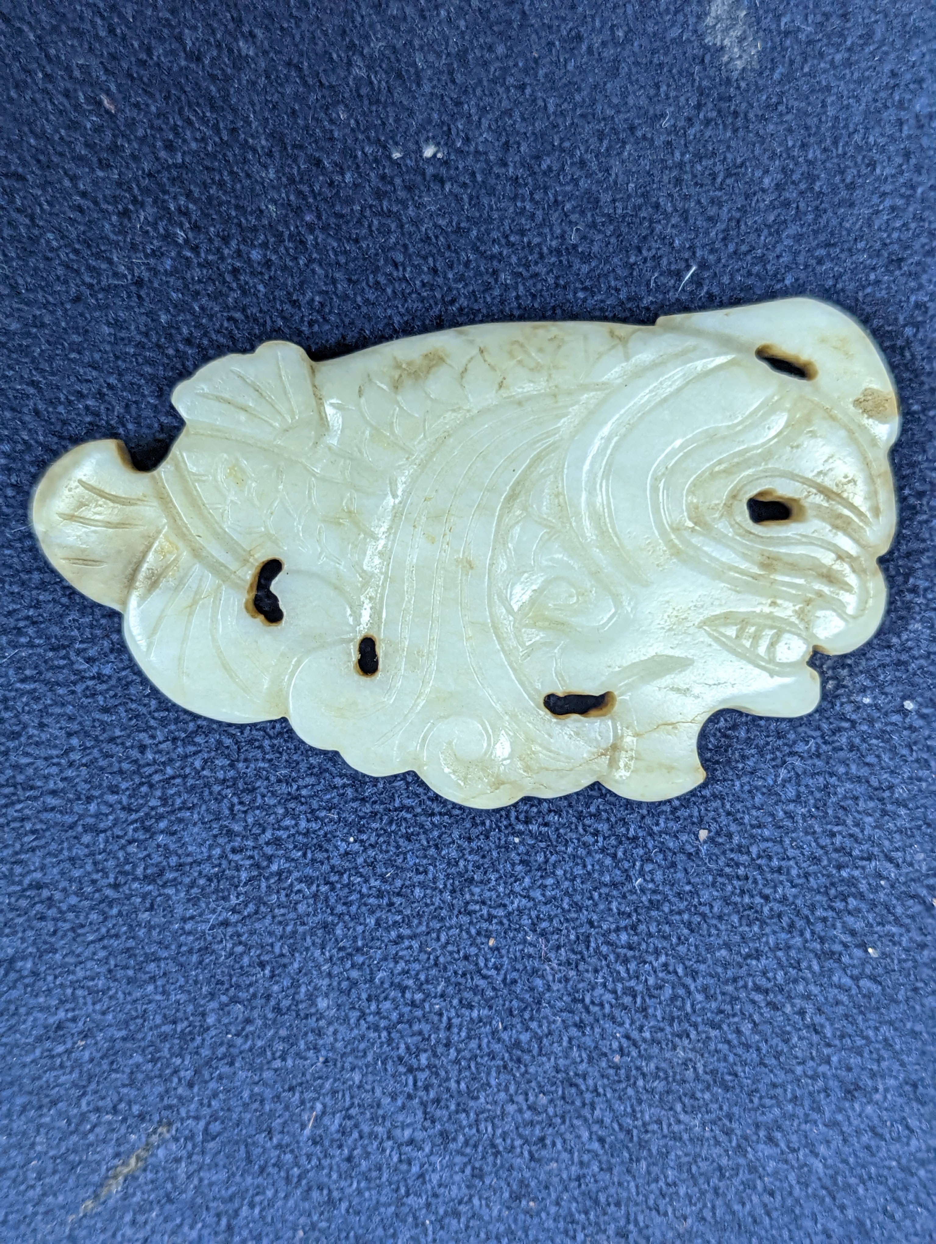 A Chinese white and black jade ‘dragon-fish’ plaque, 19th/20th century, 6cm